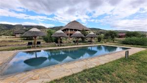 a swimming pool in front of a resort at Africa Safari Lake Natron in Mtowabaga