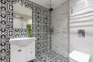 a bathroom with a toilet and a sink and a mirror at Filia Place in Athens