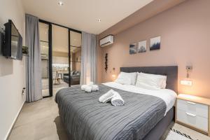 a bedroom with a large bed with towels on it at Filia Place in Athens