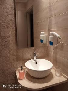 a bathroom with a white sink and a mirror at Bellarias House in Nydri