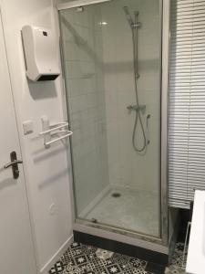 a shower with a glass door in a bathroom at STUDIO DU MARCHÉ in La Rochelle