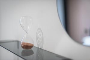 an hourglass sitting on top of a glass table at Filia Place in Athens
