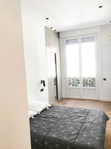 1 dormitorio con cama y ventana grande en Buffa Résidence, en Niza