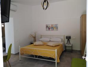 a bedroom with a bed with a yellow blanket at Casa Bellissima in Chania