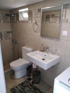 a bathroom with a white sink and a toilet at Casa Bellissima in Chania +22 photos