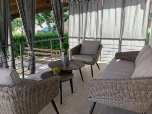 a screened in porch with two chairs and a table at Apartman studio SONAS 3 with free private parking in Karlovac