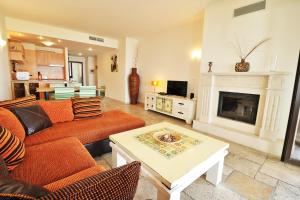 a living room with a couch and a fireplace at Kaliakria Sea View Apartments in Topola