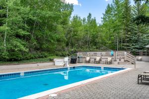 a swimming pool in the middle of a yard at 326 Kiva Condo access to Ski in Out in Avon