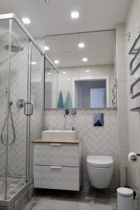 a bathroom with a shower and a toilet and a sink at Homely apartment in Kėdainiai in Kėdainiai +34 photos