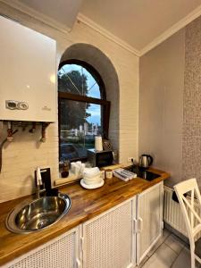 een keuken met een wastafel en een raam bij Luxury Live in Kamjanets-Podilsky