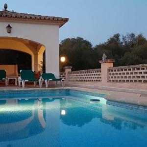a swimming pool with chairs next to a building at Finca Las Tortugas in Campos +14 photos