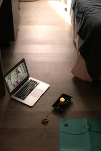 a laptop computer sitting on top of a wooden floor at ÑU Posta Urbana Hotel Boutique in Cordoba
