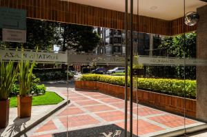 a view of the entrance to a building with glass doors at Travelers Fontana Plaza in Bogotá