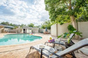 a swimming pool with a toy doll sitting on a chair next to it at Hoogwater Farmhouse in Wolseley