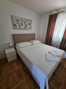 Postel nebo postele na pokoji v ubytování Apartments Ledic