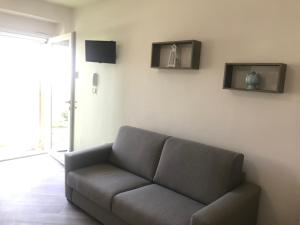 a living room with a couch and a window at Casa di Nonna Checca B&B in Leuca