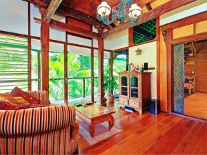 a living room with a couch and a table at Wollumbin Palms Rainforest Retreat in Uki