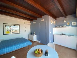 a living room with a table and a kitchen at Osservatorio sul mare in Bari