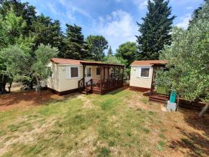 a cabin in the woods with a yard at Kamp Rujno in Starigrad