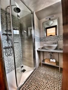 a bathroom with a shower and a sink at Abbazia delle Sorelle in Novello