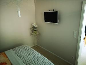 a bedroom with a bed and a tv on the wall at Grünheide am See in Alt Buchhorst +15 photos