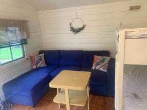 a blue couch in a room with a table at Valldal Camping in Valldal