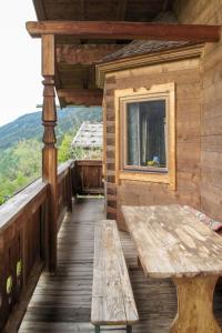 a wooden deck with a bench and a window at Apartment Geislhof - BMG195 by Interhome in Bramberg am Wildkogel