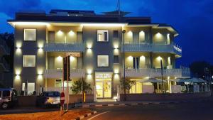 a large building with lights on the side of it at Hotel Baby in Rimini