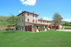 a large building with a grass field in front of it at Villa Altomonte in Marlia