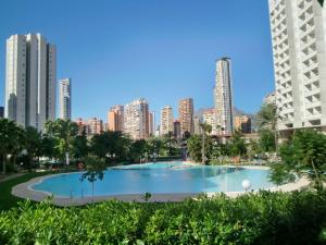 a large swimming pool with a city skyline in the background at Apartment Los Gemelos-3 by Interhome in Benidorm
