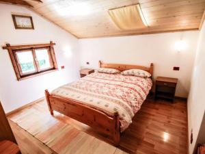 a bedroom with a bed and a wooden floor at Apartment Santa Lucia-1 by Interhome in Valdisotto