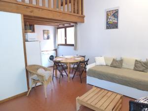 a room with a bed and a table and a kitchen at Holiday Home Les As-9 by Interhome in Lacanau-Océan