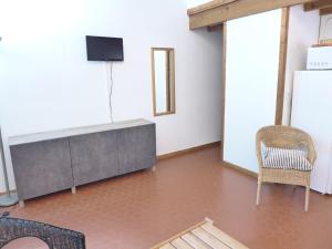 a room with a television and a table and chairs at Holiday Home Les As-9 by Interhome in Lacanau-Océan