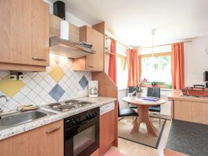 a kitchen with a sink and a stove top oven at Apartment Christian by Interhome in Ginzling