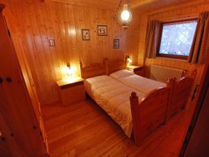 a bedroom with a bed in a wooden room at Apartment Cesa Galadriel-2 by Interhome in Penia