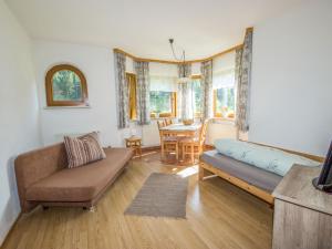 a living room with a couch and a table at Apartment Vallis Bella by Interhome in Langesthei