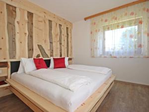A bed or beds in a room at Apartment Haus Sailer by Interhome