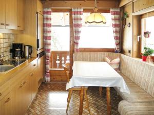 a small kitchen with a table and a window at Holiday Home Baggenhof by Interhome in Laimach +32 photos