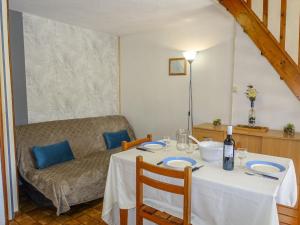 a dining room with a table and a couch at Holiday Home Les Amandines-3 by Interhome in Gruissan