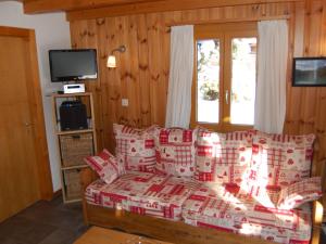 a living room with a bed with boxes on it at Chalet Coucordin by Interhome in Nendaz