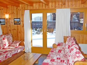 a living room with two couches and a sliding glass door at Chalet Coucordin by Interhome in Nendaz