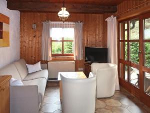 a living room with a couch and a tv at Holiday Home LUNA - IST200 by Interhome in Imst