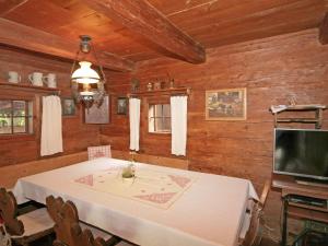 a dining room with a table and a flat screen tv at Chalet Troadkasten by Interhome in Neuhofen im Innkreis
