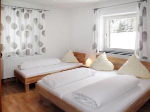 two beds in a room with a window at Apartment Altes Zollhaus-2 by Interhome in Nauders
