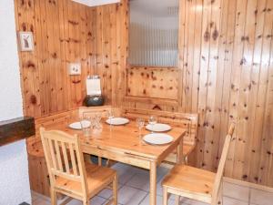 a wooden dining room with a table and chairs at Apartment Christiania 2 C8 by Interhome in Nendaz