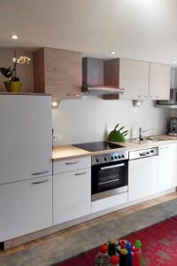 a kitchen with white cabinets and a stove top oven at Apartment Zipparashof - KPL330 by Interhome in Perpat