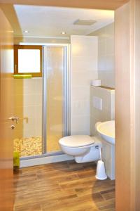 a bathroom with a toilet and a sink and a shower at Apartment Miramonte - KPL283 by Interhome in Kappl