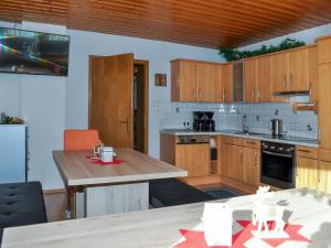 uma cozinha com armários de madeira e uma mesa de madeira em Apartment Miramonte - KPL283 by Interhome em Kappl
