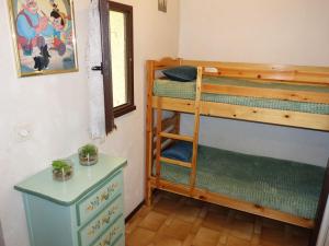 a room with two bunk beds and a table at Apartment Gruissan Port-2 by Interhome in Gruissan