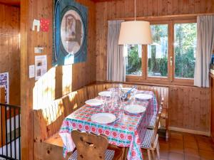 a dining room with a table with plates and glasses at Chalet Sven Heul by Interhome in Nendaz